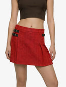 Red skirt with black buckles worn by a person on a white background