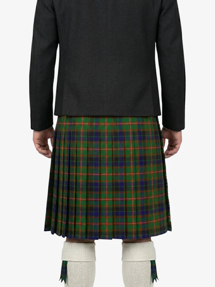 Person wearing a black jacket and green plaid kilt on a white background