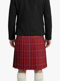 Person wearing a black jacket and red plaid kilt on a white background