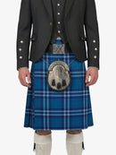Person wearing a blue plaid kilt with a black jacket on a white background