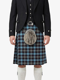 Person wearing a traditional Scottish kilt with a tartan pattern on a white background