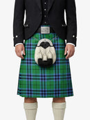 Person wearing a green and blue plaid kilt with a black jacket on a white background