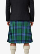 Person wearing a black jacket and green plaid kilt on a white background