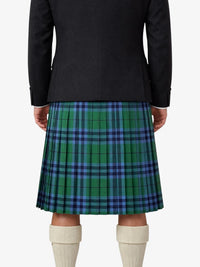 Person wearing a black jacket and green plaid kilt on a white background