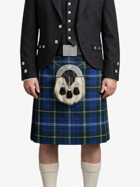 Person wearing a blue plaid kilt with a black jacket on a white background