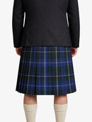 Person wearing a black jacket and blue plaid kilt on a white background
