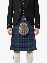 Person wearing a traditional Scottish kilt with a jacket on a white background