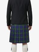 Person wearing a black jacket and blue plaid kilt on a white background