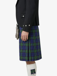 Person wearing a black jacket and blue plaid kilt on a white background
