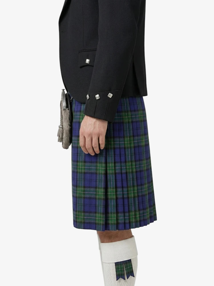 Person wearing a black jacket and blue plaid kilt on a white background