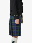 Person wearing a black jacket and blue plaid kilt on a white background