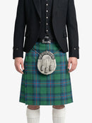 Person wearing a green plaid kilt with a black jacket on a white background