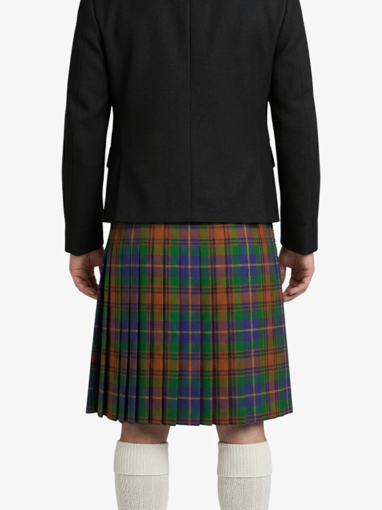 Person wearing a black jacket and a plaid kilt on a white background
