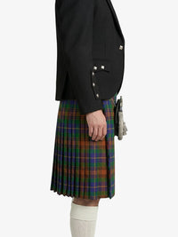 Person wearing a black blazer and plaid kilt on a white background