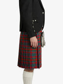 Person wearing a black blazer and red plaid kilt on a white background
