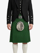 Person wearing a green tartan kilt with a black jacket on a white background
