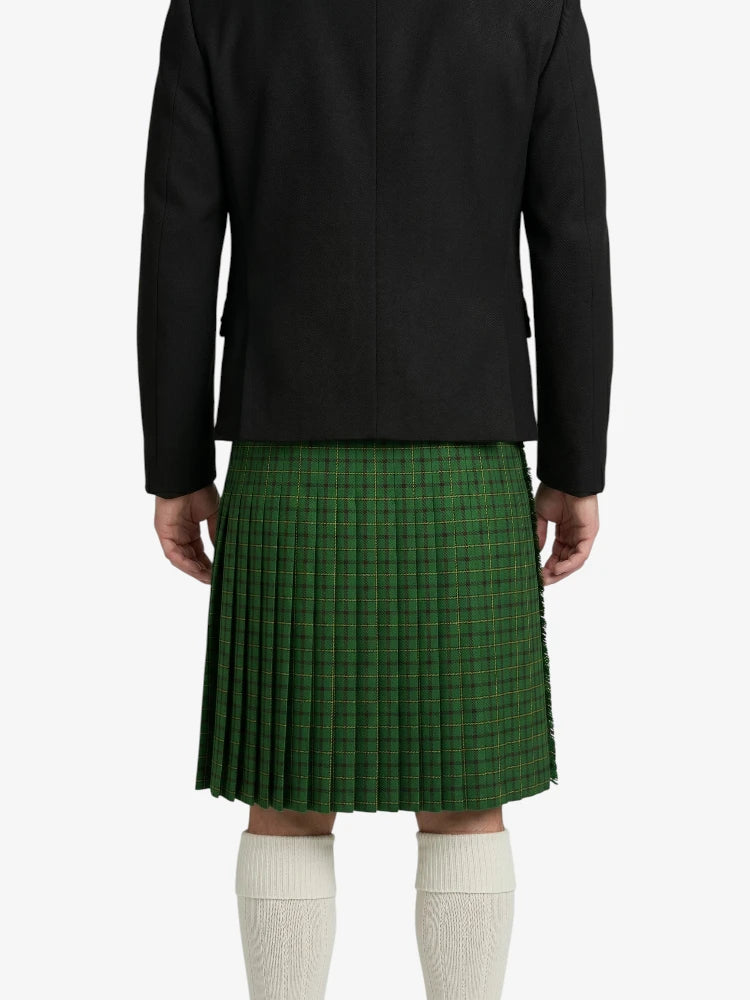 Person wearing a black jacket and green plaid kilt on a white background
