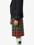Person wearing a black jacket and red plaid kilt on a white background