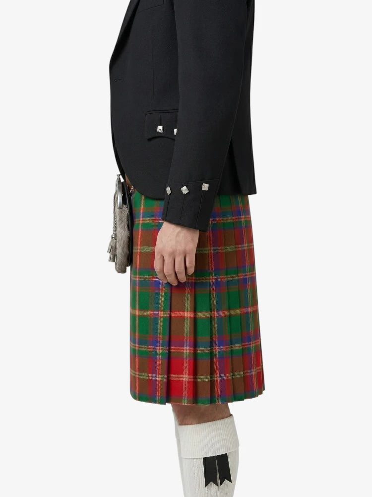 Person wearing a black jacket and red plaid kilt on a white background