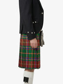 Person wearing a black jacket and red plaid kilt on a white background