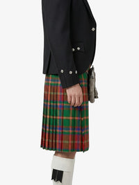 Person wearing a black jacket and red plaid kilt on a white background