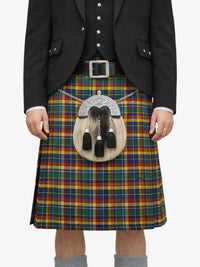 Person wearing a traditional Scottish kilt with a tartan pattern on a white background