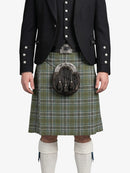 Person wearing a traditional Scottish kilt with a sporran on a white background