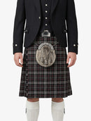 Person wearing a traditional Scottish kilt with a jacket on a white background