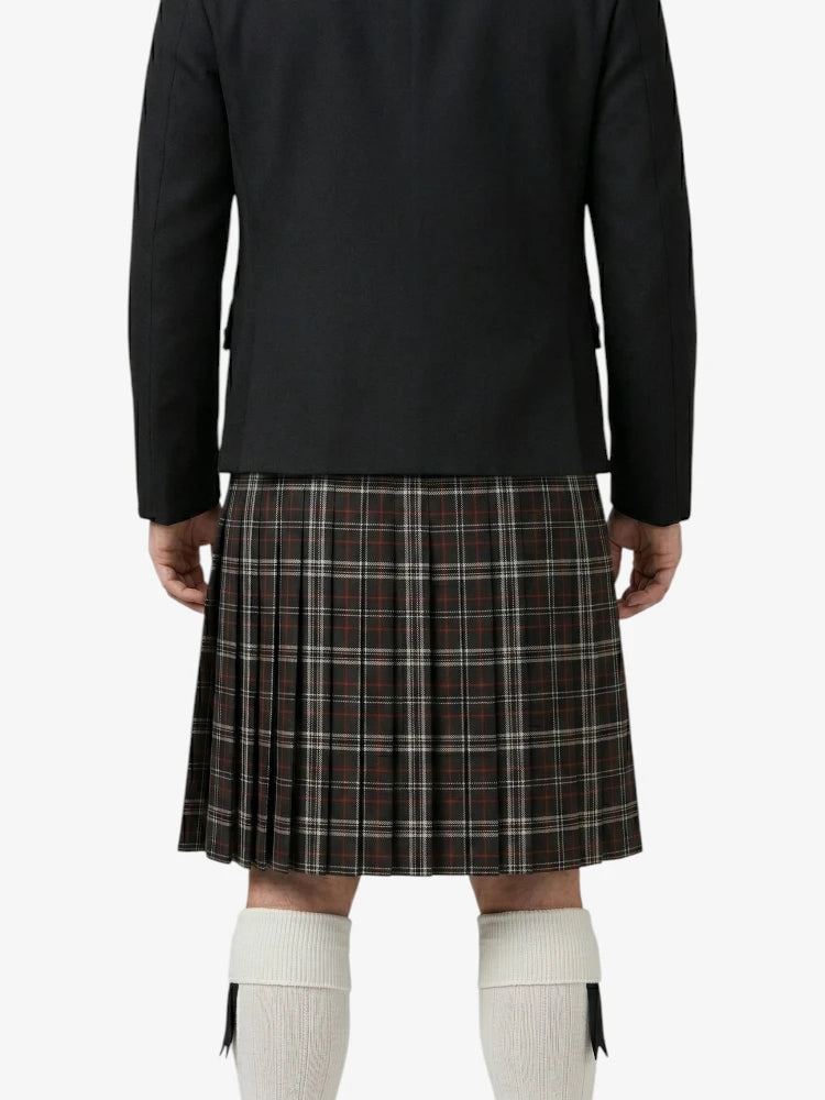 Person wearing a black jacket and plaid kilt on a white background