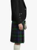 Person wearing a black blazer and plaid kilt on a white background