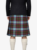 Person wearing a black jacket and plaid kilt on a white background