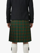 Person wearing a black jacket and green plaid kilt on a white background