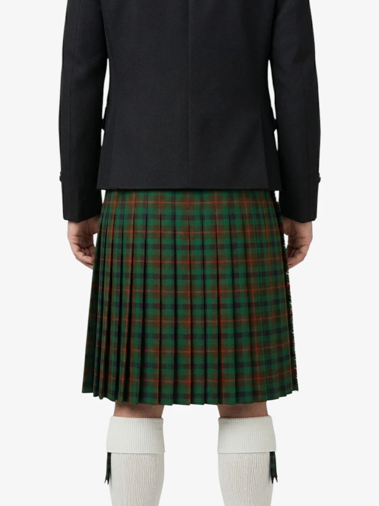 Person wearing a black jacket and green plaid kilt on a white background