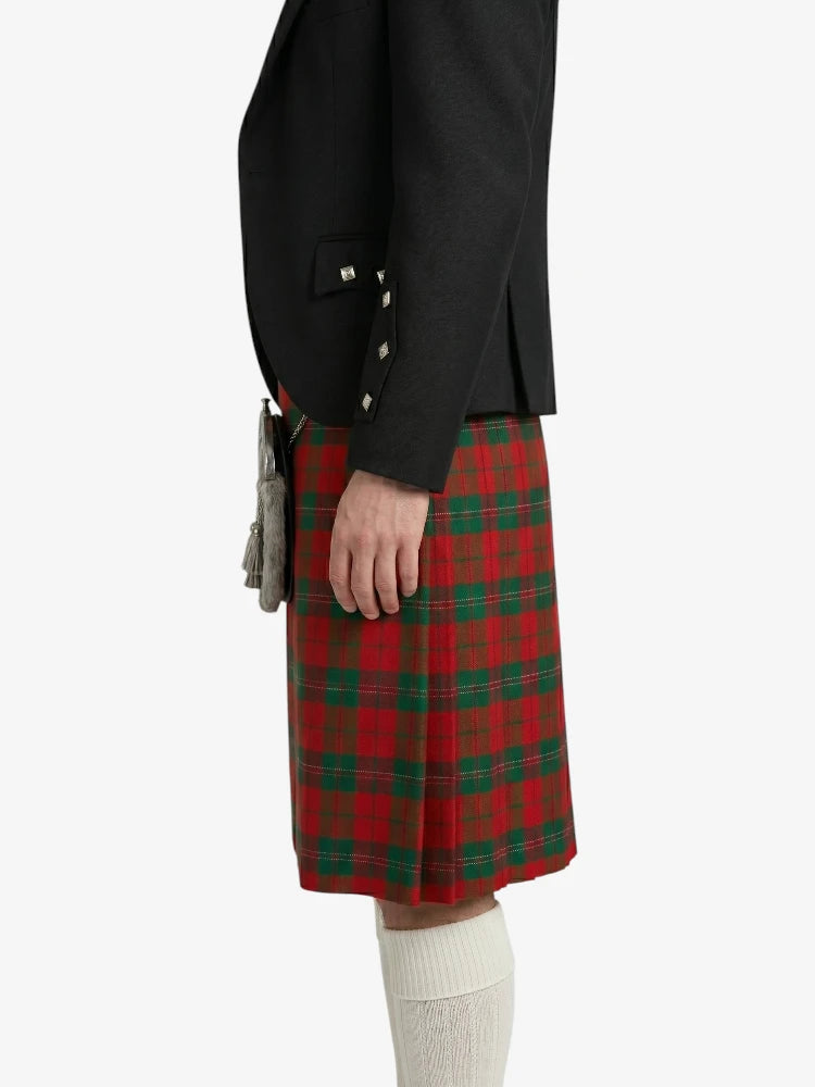 Person wearing a red plaid kilt with a black jacket on a white background
