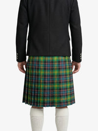Person wearing a black jacket and green plaid kilt on a white background