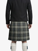 Person wearing a black jacket and plaid kilt on a white background