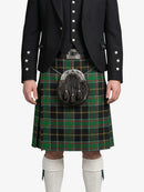 Person wearing a traditional Scottish kilt with a tartan pattern on a white background