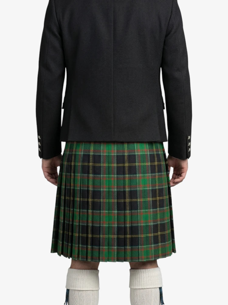 Person wearing a black jacket and green plaid kilt on a white background