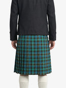 Person wearing a dark coat and blue plaid kilt on a white background