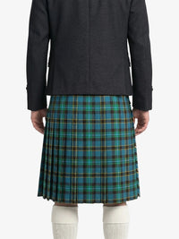 Person wearing a dark coat and blue plaid kilt on a white background