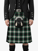 Person wearing a traditional Scottish kilt with a tartan pattern on a white background