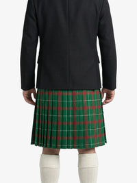 Person wearing a black coat and green plaid kilt on a white background