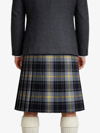 Person wearing a dark gray jacket and plaid kilt on a white background