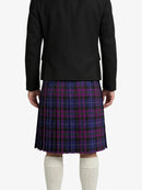 Person wearing a black jacket and purple plaid kilt on a white background
