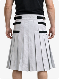 White pleated skirt with black straps worn by a person on a white background