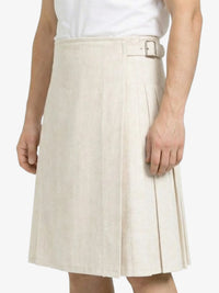 Beige pleated skirt worn by a person on a white background