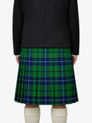 Person wearing a green and blue plaid kilt with a black jacket on a white background