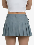 Person wearing a gray pleated skirt on a white background