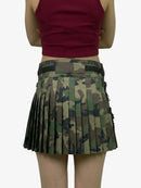 Person wearing a red top and camouflage pleated skirt on a white background